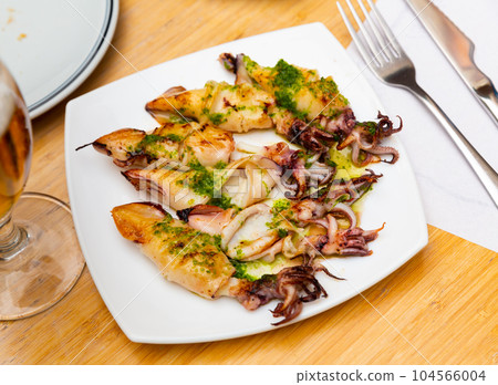 Traditional asian dish is barbecue squid,drizzled with spinach sauce. 104566004