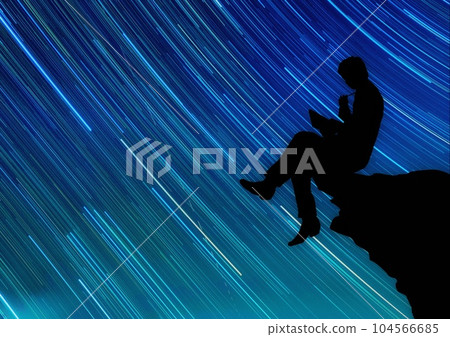 Silhouette of a person meditating against the background of the starry sky 104566685