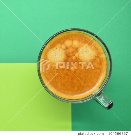 glass of hot black coffee put on green background 104566867