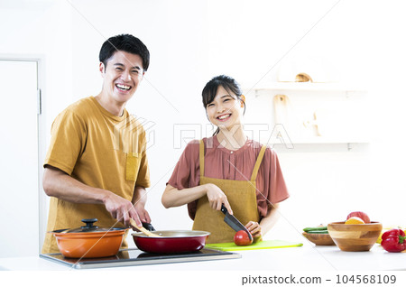 young couple cooking 104568109
