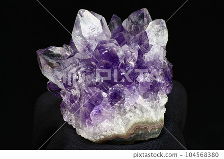 Bright beautiful amethyst druse on a dark background Bright beautiful amethyst druse on a dark background 104568380