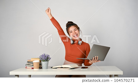 A cheerful Asian college student celebrating with herself after hearing the good news. A cheerful Asian college student celebrating with herself after hearing the good news. 104570271