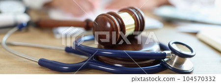 Judge hammer and doctor stethoscope on office desk Judge hammer and doctor stethoscope on office desk 104570332