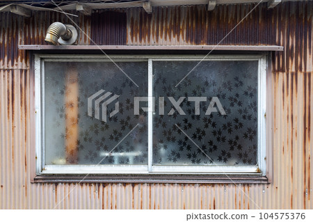 Window with leaf pattern in abandoned house, Kanazawa, Japan. 104575376