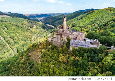 aerial view rock with medieval castle Ehrenburg on it near moselle river in Brodenbach with forest hills aerial view rock with medieval castle Ehrenburg on it near moselle river in Brodenbach with forest hills 104576481