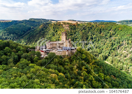 aerial view rock with medieval castle Ehrenburg on it near moselle river in Brodenbach with forest hills 104576487