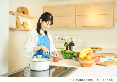 Woman cooking Woman cooking 104577318