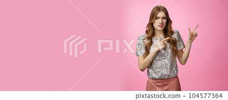 Unsure reluctant attractive glamour caucasian girl asking question doubtful pointing upper right corner lost seeking address party, grimacing cringe hesitant, standing uncertainpink background 104577364