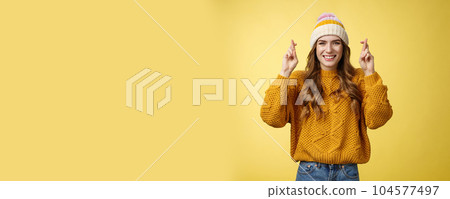 Optimistic lucky cute young stylish female university student praying god help pass exams cross fingers good fortune smiling broadly faithfully hope receive good news, make wish yellow background Optimistic lucky cute young stylish female university student praying god help pass exams cross fingers good fortune smiling broadly faithfully hope receive good news, make wish yellow background 104577497