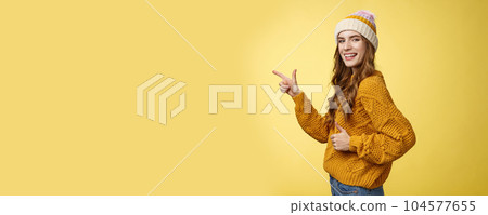 Profile shot charismatic flirty good-looking satisfied young girl turn camera pointing index finger left show thumbs-up like gesture approving recommending awesome place yellow background 104577655