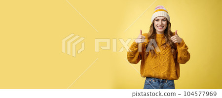 Supportive attractive 20s girl likes your idea show thumbs up positive reply affirmative answer standing pleased smiling recommending promotion satisfied give approval, agree yellow background Supportive attractive 20s girl likes your idea show thumbs up positive reply affirmative answer standing pleased smiling recommending promotion satisfied give approval, agree yellow background 104577969