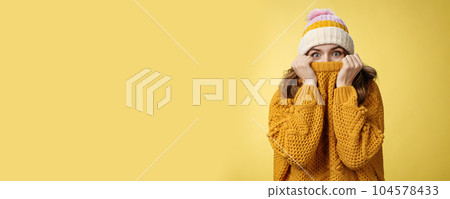 Charming playful charismatic girl hiding face pull sweater collar nose widen eyes surprised happy fool around having fun enjoying winter vacation mountains escape cold wearing warm clothes 104578433