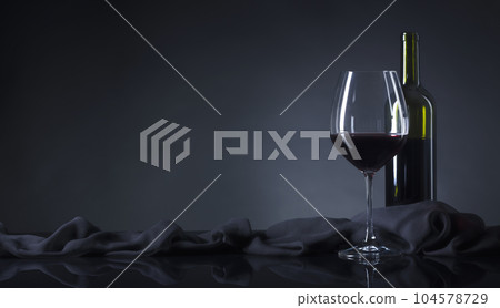 Glass and bottle of red wine. Glass and bottle of red wine. 104578729