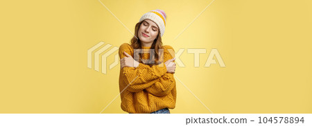 Tender sensual charming young girlfriend dreaming close eyes flirty smiling tilting head embracing herself recalling nice romantic memories wanna hold boyfriend tight, cuddling yellow background Tender sensual charming young girlfriend dreaming close eyes flirty smiling tilting head embracing herself recalling nice romantic memories wanna hold boyfriend tight, cuddling yellow background 104578894
