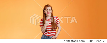 Carefree modern 20s female student chatting friends discuss left copy space, pointing left relaxed casual pose, smiling camera joyfully, introduce advertisement product, orange background Carefree modern 20s female student chatting friends discuss left copy space, pointing left relaxed casual pose, smiling camera joyfully, introduce advertisement product, orange background 104579217