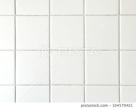 white tile wall in bathroom 104579481