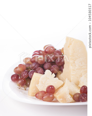 grapes and parmesan. Parmesan cheese and grapes isolated on a white backgroun. View from above 104580317