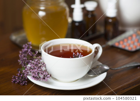 Still life from medicinal herbs, honey, herbal tea and medicines 104580321
