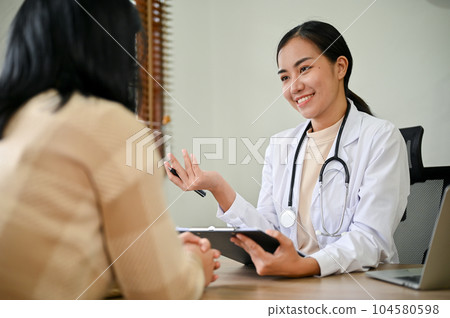 Young female doctor diagnose female patient in her clinic room. 104580598