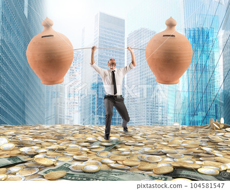 Powerful and determined businessman trains with a barbell with piggy banks 104581547