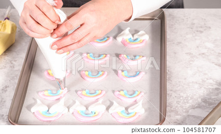 Step by step. Piping meringue mix into unicorn-shaped pops on a baking sheet lined with parchment paper. Step by step. Piping meringue mix into unicorn-shaped pops on a baking sheet lined with parchment paper. 104581707