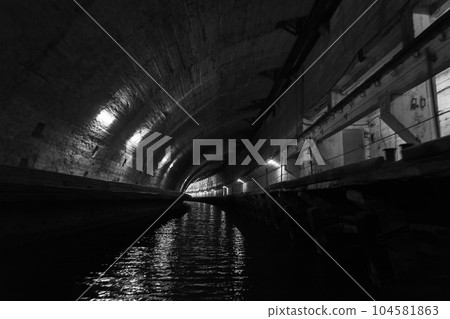 Industrial dark concrete tunnel perspective. Aandoned underground submarine base Industrial dark concrete tunnel perspective. Aandoned underground submarine base 104581863