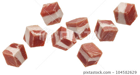Falling bacon cubes, diced smoked ham isolated on white background 104582629