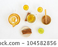 Top view of a cup of tea with ginger root, lime, cinnamon and teapot on white background. Health drink concept.. 104582856