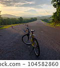 Bike at sunset,mountain,blue sky. Din Dam Thapha, Sirikit Dam uttaradit Thailand.Bike at sunset,mountain,blue sky. Din Dam Thapha, Sirikit Dam uttaradit Thailand. 104582860