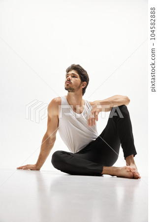 Young handsome Caucasian man wearing homewear posing over white studio background. Concept of men's health, beauty of male body, fashion, ad 104582888