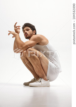 Portrait of handsome young dark-haired man posing isolated over studio background. Male natural beauty concept. Portrait of handsome young dark-haired man posing isolated over studio background. Male natural beauty concept. 104582890