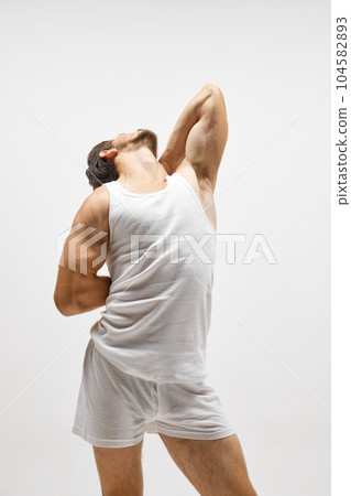 Portrait of handsome young dark-haired man posing isolated over studio background. Male natural beauty concept. 104582893
