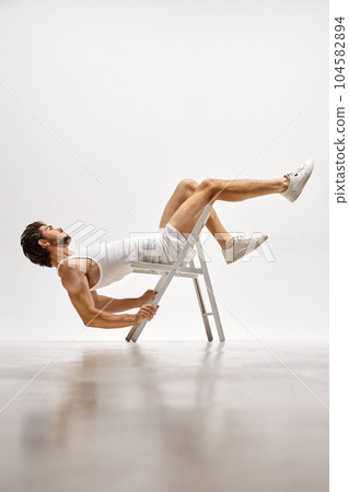 Muscular male fashion model wearing cotton underwear posing isolated over white background. Concept of men's health, beauty, fitness, fashion. Muscular male fashion model wearing cotton underwear posing isolated over white background. Concept of men's health, beauty, fitness, fashion. 104582894
