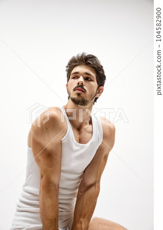 Muscular male fashion model wearing cotton underwear posing isolated over white background. Concept of men's health, beauty, fitness, fashion. Muscular male fashion model wearing cotton underwear posing isolated over white background. Concept of men's health, beauty, fitness, fashion. 104582900