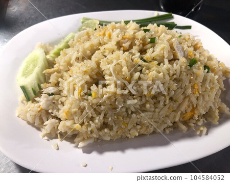 Khao Pad fried rice eaten at a food stall in Bangkok 104584052