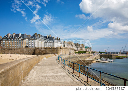 St Malo, France. View over the walled city Saint-Malo medieval pirate fortress, St Vincent Cathedral and lighthouse from the sea in Summer Daytime, Brittany St Malo, France. View over the walled city Saint-Malo medieval pirate fortress, St Vincent Cathedral and lighthouse from the sea in Summer Daytime, Brittany 104587187