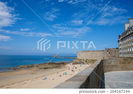 St Malo, France. View over the walled city Saint-Malo medieval pirate fortress, St Vincent Cathedral and lighthouse from the sea in Summer Daytime, Brittany St Malo, France. View over the walled city Saint-Malo medieval pirate fortress, St Vincent Cathedral and lighthouse from the sea in Summer Daytime, Brittany 104587194
