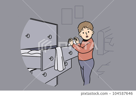 Little boy is standing near closet with clothes, looking at textiles with curiosity 104587646