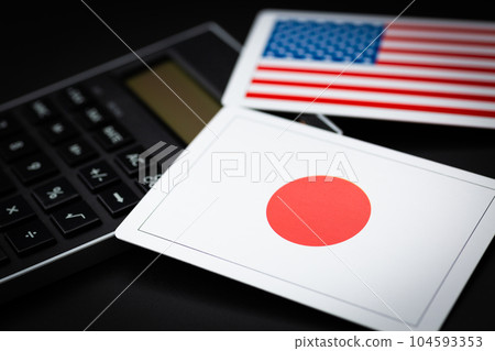 Japanese and American flags and calculators 104593353