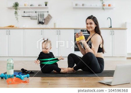 Baby learning exercises with stretch band from mom at home Baby learning exercises with stretch band from mom at home 104596368