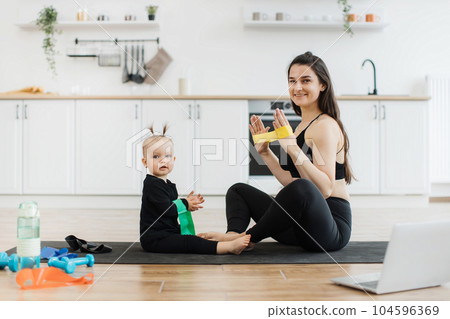 Baby learning exercises with stretch band from mom at home Baby learning exercises with stretch band from mom at home 104596369