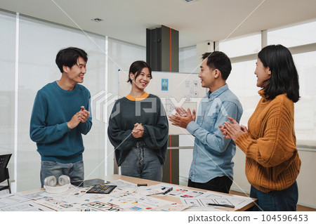 Team of ux developer and ui designer brainstorming interface wireframe design.Creative digital development agency Team of ux developer and ui designer brainstorming interface wireframe design.Creative digital development agency 104596453