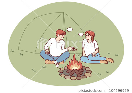 Man and woman relaxing near campfire 104596959