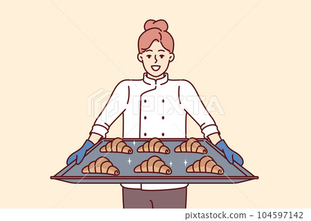Woman baker holds tray of croissants preparing fresh pastries for sale in own bakery. 104597142