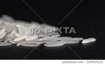 White rice on a black graphite stone slab White rice on a black graphite stone slab 104597229