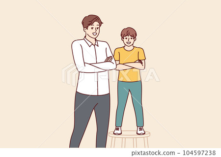 Father and son smiling standing with arms crossed and looking at screen for concept of parenthood 104597238