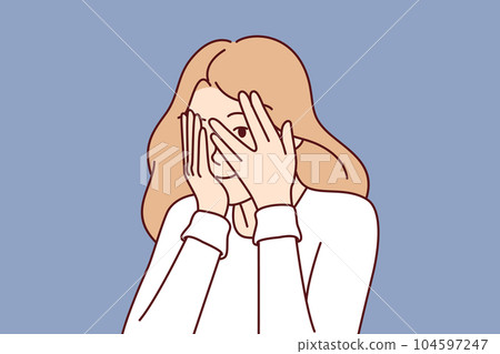 Woman covers eyes with hands and peeps, refusing to see unpleasant things and hiding from problems Woman covers eyes with hands and peeps, refusing to see unpleasant things and hiding from problems 104597247