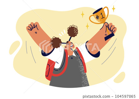 Schoolgirl with golden cup celebrates victory in school olympiad and raises hands up 104597865