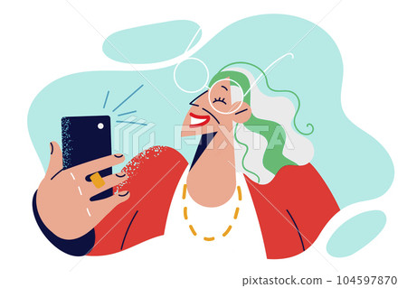 Elderly woman takes selfie on phone and smiling poses for picture for social network 104597870