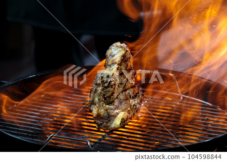 Grill steak tomahawk. Angus beef tbone on fire flame 104598844
